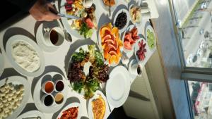 a table with plates of food on a wall at Grand Urfa Hotel in Urfa