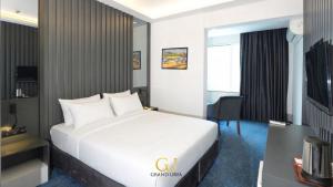 a hotel room with a bed and a tv at Grand Urfa Hotel in Urfa