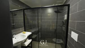 a bathroom with a sink and a glass shower at Grand Urfa Hotel in Urfa