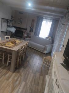 a living room with a table and a couch at La Piemontesina in Nizza Monferrato