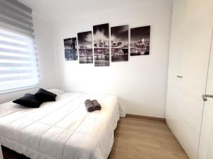 a bedroom with a bed and some pictures on the wall at Rhode 2a in Roses