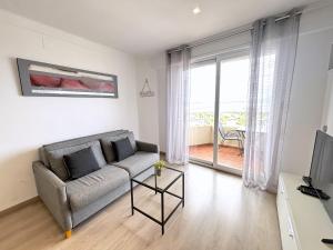 a living room with a couch and a table at Rhode 2a in Roses +12 photos