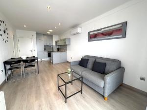 a living room with a couch and a table at Rhode 2a in Roses