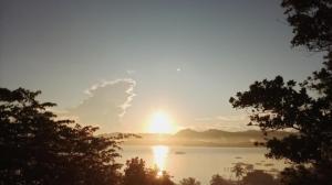 a sun setting over a large body of water at MountainSide Lodge in El Nido