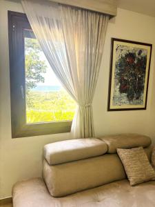 a living room with a couch and a window at El Mar House in Petrovac na Moru +40 photos