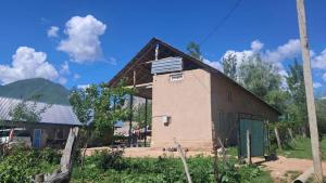 a house with a roof that is being built at Belek Gust house in Toktogul