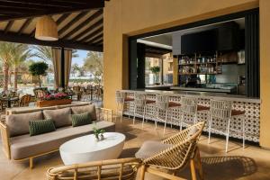 a restaurant with a couch and chairs and a bar at Hotel Solea, Autograph Collection in Carlsbad
