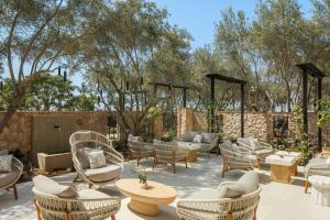 a patio with couches and tables and chairs at Hotel Solea, Autograph Collection in Carlsbad