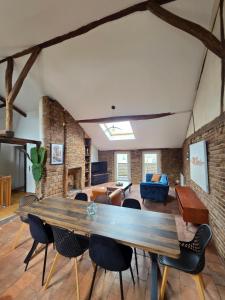 a living room with a large wooden table and chairs at Les terrasses de la moine in Cholet