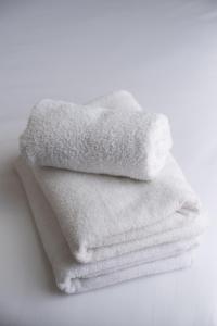 a pile of white towels sitting on a table at Iveagh Lodge in Dublin +29 photos