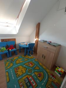 a childs room with a table and a rug at Gerber Garden in Villány