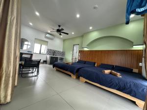 a bedroom with two beds with blue sheets at Roooftop villa can ho penhouse Tay ninh in Tây Ninh +52 photos