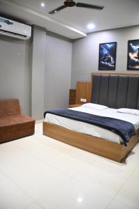 a bedroom with a bed and a ceiling fan at Hotel 60 in Bhucho
