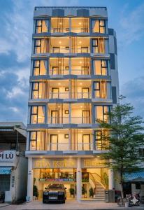 a building with a car parked in front of it at Gia Kiên Hotel in Quy Nhon