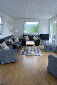 a living room with couches and a coffee table at Havblikk, cozy cabin by the sea with beautiful views in Mandal