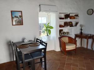 a dining room with a table and a chair at HelgaHome in Las Breñas