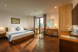 a hotel room with a bed and a desk at Hanoi Sail Hotel in Hanoi
