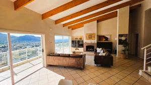 a large living room with a couch and a fireplace at Sea Sands Villa in Fish Hoek
