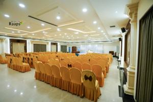a banquet hall with orange chairs in a room at Hotel SVM Grand Koti in Hyderabad