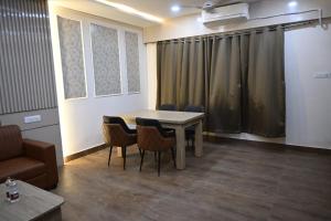 a conference room with a table and chairs and a couch at Hota Residency in Sonepur