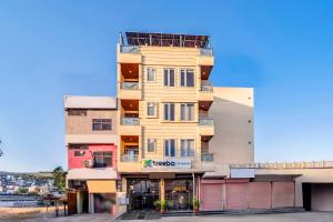 a tall yellow building with balconies on it at Anandam Hotel in Jaipur