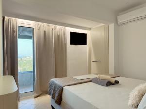 a bedroom with a bed and a large window at Alex Apartment Suites in Virós +45 photos
