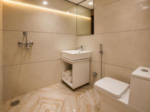 a bathroom with a sink and a toilet at Hotel Grand Lucent Mathura-Vrindavan in Gokul +20 photos