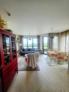 a living room with a couch and a table at Tranquility Apartment Pirin Golf in Razlog