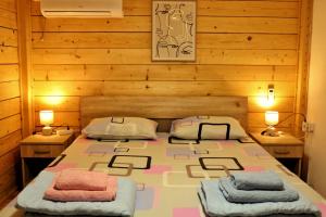 a bedroom with a large bed with two night stands at Kucica Enterprise-Ada Bojana in Ulcinj