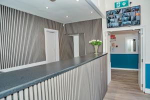 a lobby with a counter and a hallway with a pharmacy at Iveagh Lodge in Dublin
