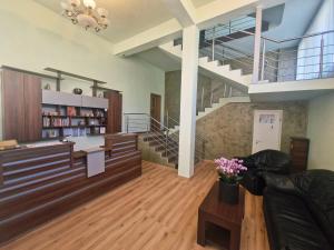 a living room with a staircase and a couch at Boutique Global in Braşov