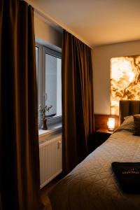 a hotel room with a bed and a window at ADELA VIP Nezábudka - Tiché krídlo, 45m2 a TOP spánok in Tatranska Strba +34 photos