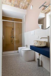a bathroom with a toilet and a sink and a shower at Lanizoladelroero in Sommariva Perno +37 photos