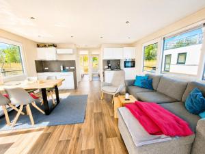 a living room with a couch and a table at Floatinghouse Milan - LP9 in Vetschau
