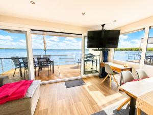 a living room with a view of the water at Floatinghouse Milan - LP9 in Vetschau +18 photos