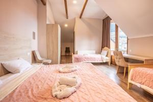 a large room with two beds and a desk at Seti Mestia Hotel in Mestia +27 photos