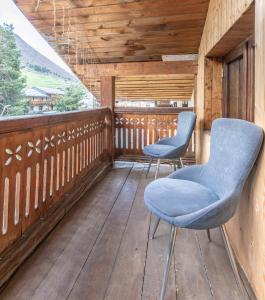 two chairs on the balcony of a cabin at Seti Mestia Hotel in Mestia