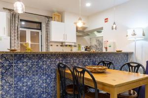 a kitchen with a wooden table and chairs at Family House in Aveiro