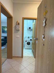 an open door to a laundry room with a washing machine at Apartman Emaus in Međugorje
