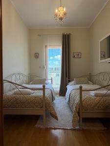 a bedroom with two beds and a window at Apartman Emaus in Međugorje
