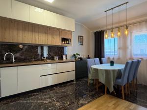 a kitchen and dining room with a table and chairs at Apartman Emaus in Međugorje