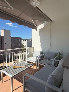 a balcony with chairs and a table on a balcony at Apartman Emaus in Međugorje