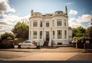 a white house with a car parked in front of it at Hidden get away in Lewes in Lewes