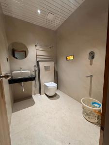 a bathroom with a toilet and a sink at Dusk and Dawn Beach Resort in Rāmeswaram