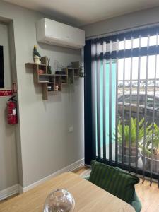 a dining room with a table and a large window at Salina Ria Studio 2 in Aveiro +2 photos
