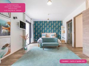 a bedroom with a bed and a blue chair at Grande Maison familiale - Piscine privée & Jardin clos - 10min Avignon & Château-neuf-du-Pape - Climatisation - Parking privé gratuit - Animaux admis in Sorgues +35 photos