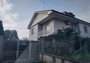a white house with a fence in front of it at La Piemontesina in Nizza Monferrato