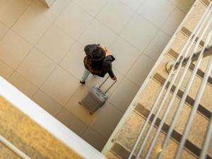 an overhead view of a woman standing next to a toilet at Mercure Florianópolis in Florianópolis