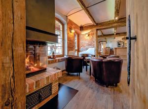 a living room with a fireplace and a bar at Landhaus Brodack in Alt Zauche