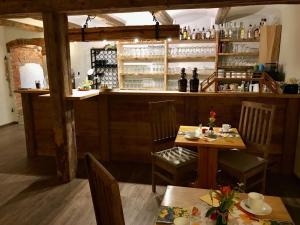 a restaurant with two tables and a bar at Landhaus Brodack in Alt Zauche